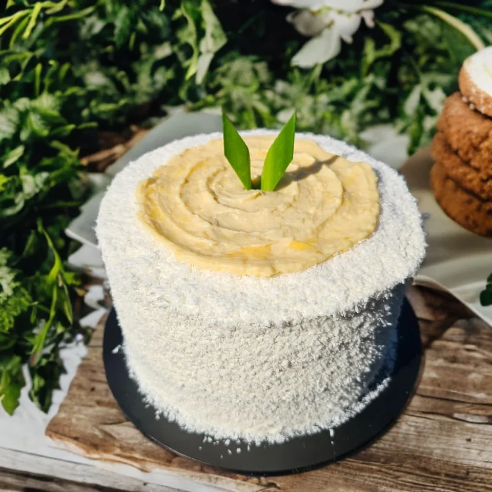Pandan gula melaka durian cake by Amour Desserts with a coconut-covered finish