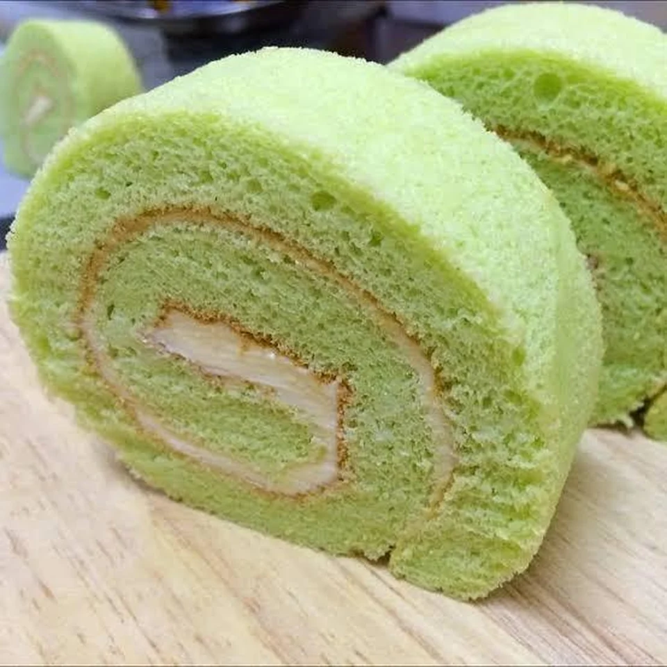 Pandan vanilla Swiss roll by Amour Desserts with green sponge and pale cream filling